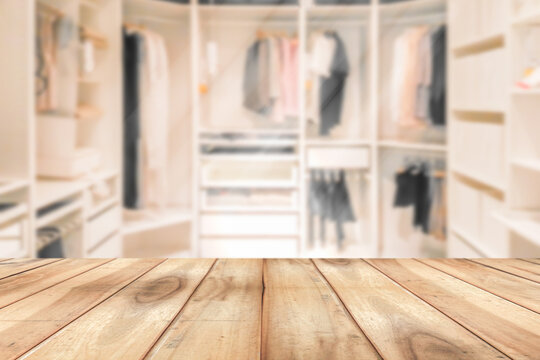 Empty wooden table on a background blur closet in the room  for display or montage your products