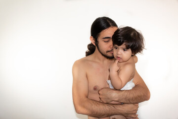 Naklejka premium portrait of a hispanic father and son hugging on a white background