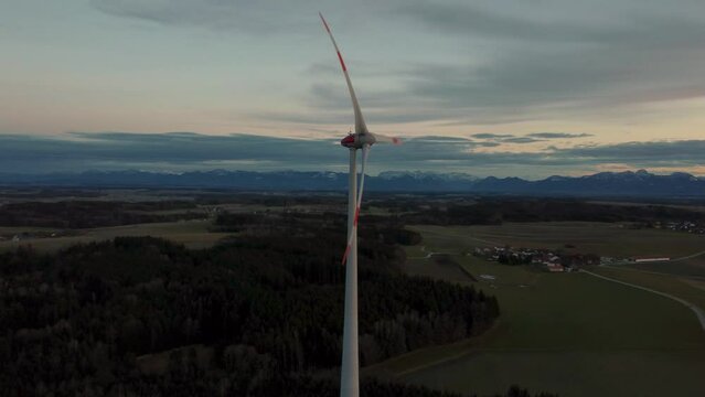 Wind turbine with rotor located in rural environment by the Alps in the district Ebersberg in Bavaria. The 10h rule prevents the construction of modern renewable and sustainable energy. Aerial drone