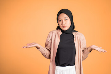 confused young muslim woman opening both palms