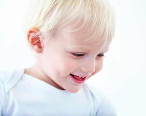 Filled with curiosity and wonder. Shot of a smiling baby boy.