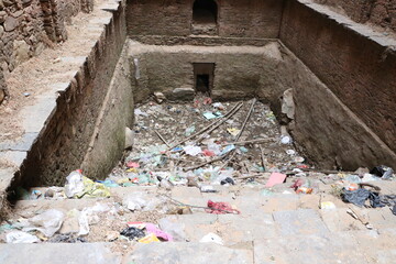 dry old water pond in plastic garbage.