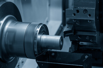 The  CNC lathe machine forming  cutting the metal shaft parts.