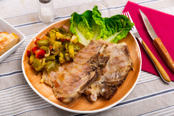 Pork steak with stewed vegetables closeup