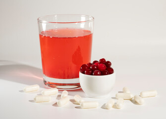 Glass of cranberry juice, cranberries, vitamins.