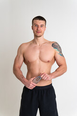 Male drink-water fitness is pumped with a towel on a white background isolated strong athlete lifestyle, training healthy gym adult sportive, background Strength copy perfect, tired one muscle