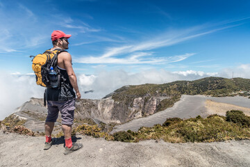 hiker with backpack contemplating the landscape in the Irazu Volcano National Park in Costa Rica