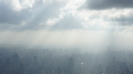 The beautiful city overlook view from the top of one skyscraper with the cloudy sky