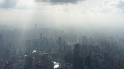 The beautiful city overlook view from the top of one skyscraper with the cloudy sky