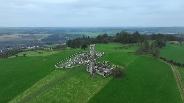 Hill of Slane, County Meath, Ireland, January 2022. Drone orbits the ruined friary church at a higher altitude from the east.