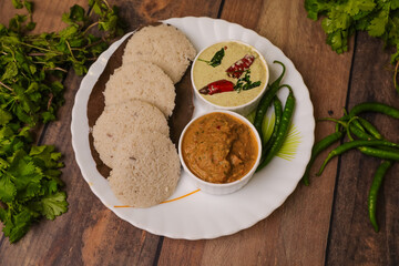 South indian famous break fast idly with chutneys in a place  closeup with selective focus and blur