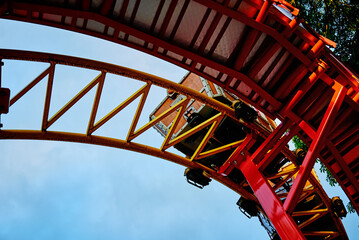 Part of looping roller coaster at summer day, Riding a rollercoaster at amusement park