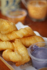 Deep fried doughstick, Chinese snack food served with boiled rice or soy milk or sweet milk or custard in breakfast, Selective focus and free space for text. Popular of street food.