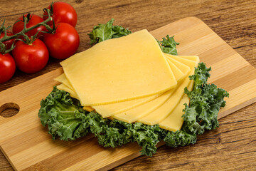 Sliced Gauda cheese over board