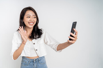 Asian woman holding a smart phone for selfie or video call