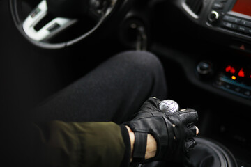 Fototapeta na wymiar Hand on the car gear knob. The driver switches the speed in the car. Hand on gear lever.