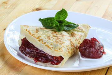 Delicous pancake with fruit jam