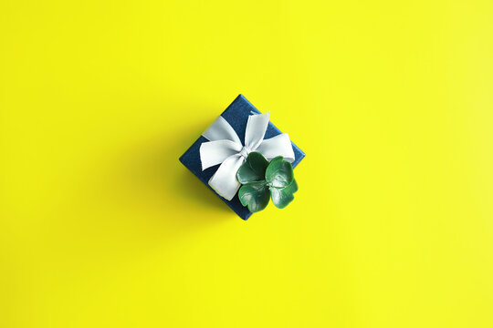 St. patrick's day background. Religious Christian Irish celebration. Four-leaf clover symbol of good luck with gift box.