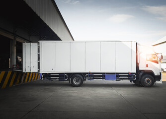 Cargo Container Trucks Parked Loading at Dock Warehouse. Shipping Cargo Trucks. Distribution...