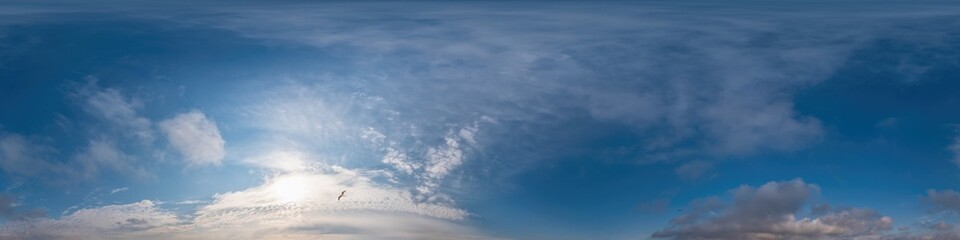 Blue sky panorama with Cirrus clouds in Seamless spherical equirectangular format. Full zenith for use in 3D graphics, game and editing aerial drone 360 degree panoramas for sky replacement.