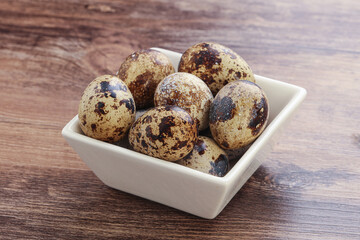 Raw quail eggs heap in the bowl