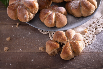 Yeast buns on a wooden table with copy space. Cozy, homemade cakes.