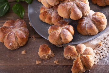 Yeast buns on a wooden table with copy space. Cozy, homemade cakes.