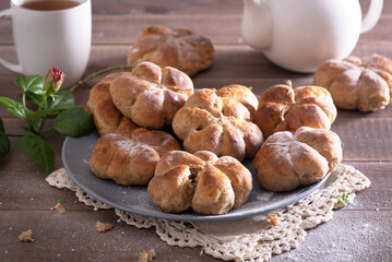 Yeast buns on a wooden table with copy space. Cozy, homemade cakes.