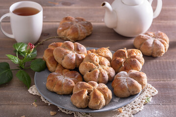 Yeast buns on a wooden table with copy space. Cozy, homemade cakes.