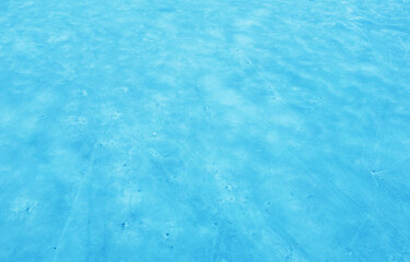 Aerial view of the beautiful blue texture of ice on the surface of the lake in winter