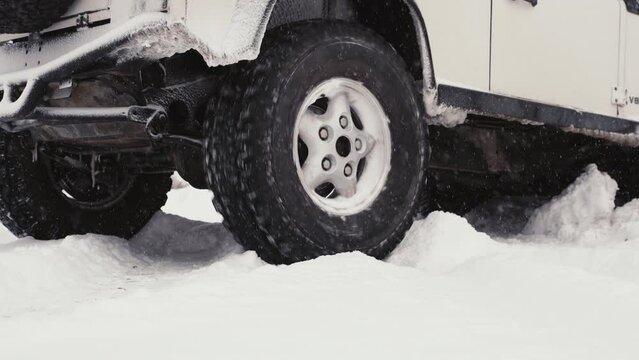 Landrover Defender D90 Stuck In Snow Burning Out Tire With Snowfall.