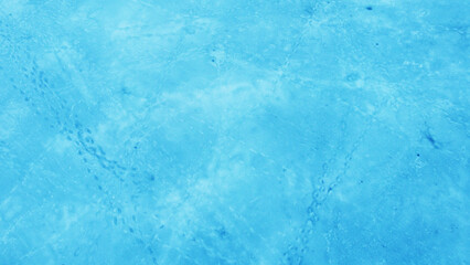 Aerial view of the beautiful blue texture of ice on the surface of the lake in winter