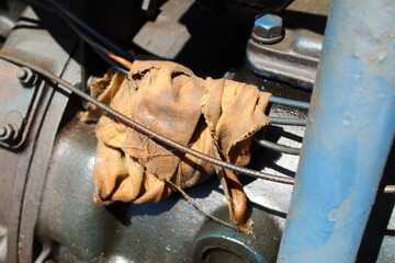 Oily rag resting on cables of vintage tractor.
