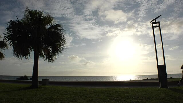 CHTAN-CHO, OKINAWA, JAPAN - AUGUST 2021 : View of Araha beach (Ocean or sea) in dusk. Sunset sky and sea. Romantic summer holiday, vacation and resort concept video.
