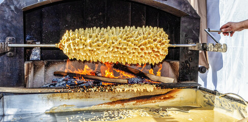 Traditional Lithuanian cake Sakotis is baked on the fire