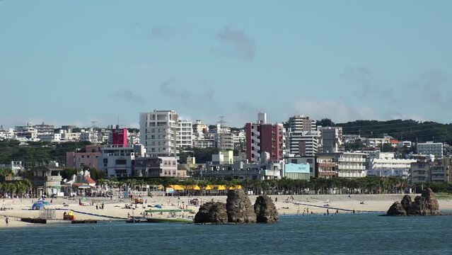 CHTAN-CHO, OKINAWA, JAPAN - AUGUST 2021 : View of Araha beach (Ocean or sea). Wide view, time lapse shot in daytime. Summer holiday, vacation and resort concept video.