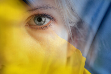 Yellow-blue national flag of Ukraine and the face of a girl, stop the war and peace in Ukraine, freedom for Ukraine, stop