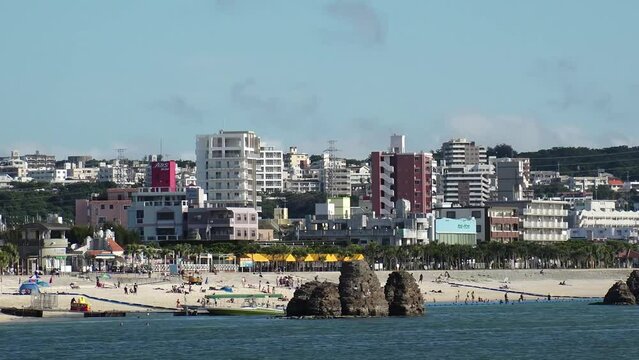 CHTAN-CHO, OKINAWA, JAPAN - AUGUST 2021 : View of Araha beach (Ocean or sea). Wide view, time lapse shot in daytime. Summer holiday, vacation and resort concept video.