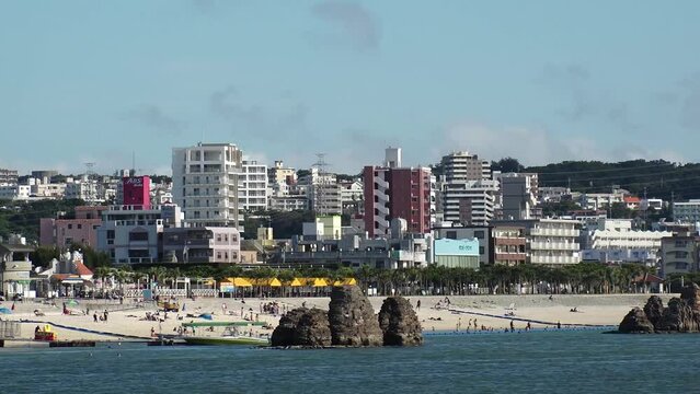 CHTAN-CHO, OKINAWA, JAPAN - AUGUST 2021 : View of Araha beach (Ocean or sea). Wide view, time lapse shot in daytime. Summer holiday, vacation and resort concept video.