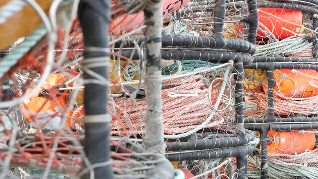 Traps, ropes and cages on pier, commercial dock, fishing industry, Monterey California USA. Empty pots, creels for fish seafood catching in port. Many fisherman's nets and baskets in seaport. Fishery.