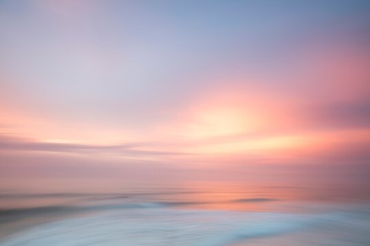 Scenic view of sea under sky at sunset