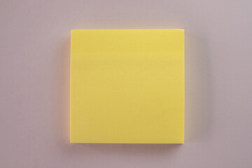 Blank Yellow sticky note on purple paper background.,cliping path include sticky note.,Cut out stationery or memo pad.