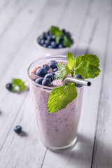 Fototapeta na wymiar blueberry or mixed berry milk shake in a glass served for refreshment, healthy eating, dieting, morning breakfast