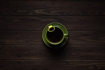 A big cup of hot tea on wooden background, overhead shot, copy space