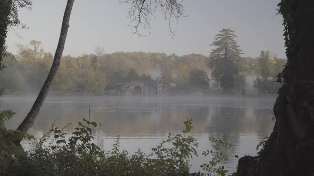 Grotto cave at Majolan Park lake in Blanquefort France artificially made, Dolly left shot