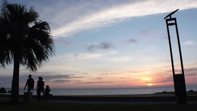 CHTAN-CHO, OKINAWA, JAPAN - AUG 2021 : View of Araha beach (Ocean or sea) in sunset time. Wide view, long time lapse shot, dusk to night. Summer holiday, vacation and resort concept shot.