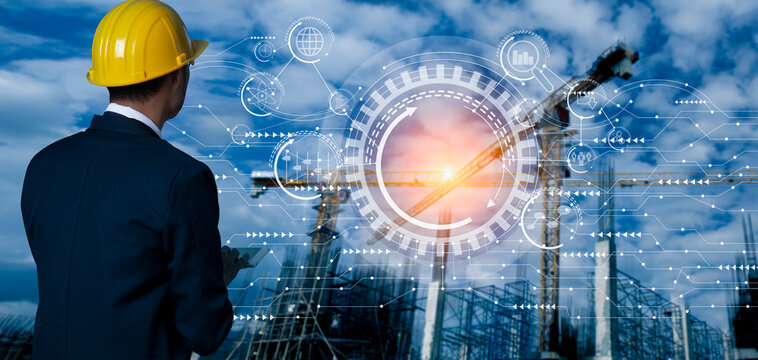 Future Building Construction Engineering And Technology Project Concept. Double Exposure Graphic With Engineer Using Digital Tablet And Smart Industry And IOT Software To Control Operation.