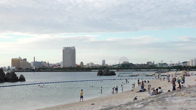 CHTAN-CHO, OKINAWA, JAPAN - AUG 2021 : View of Araha beach (Ocean or sea) in sunset time. Wide view, long time lapse shot, dusk to night. Summer holiday, vacation and resort concept shot.