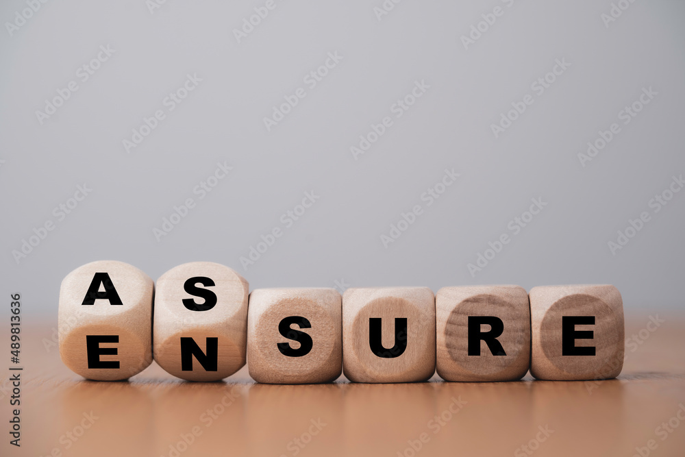 Poster  Flipping wooden cube block for change between Assure and Ensure for Insurance and assurance concept.