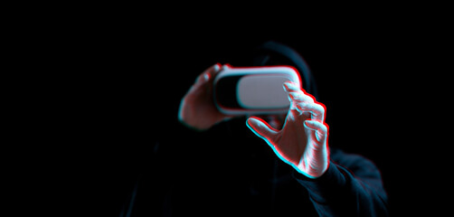 Vr glasses virtual reality. Blured young man in digital headset for virtual reality technology on dark background with glitch effect. Amazing technology, online game, entertainment.